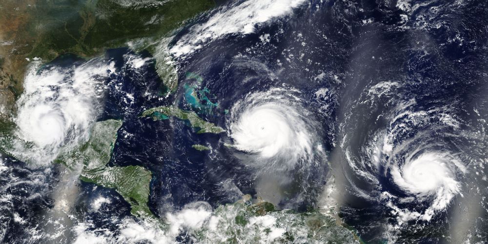 satellite view of multiple hurricanes occurring in the Atlantic near North and Central America