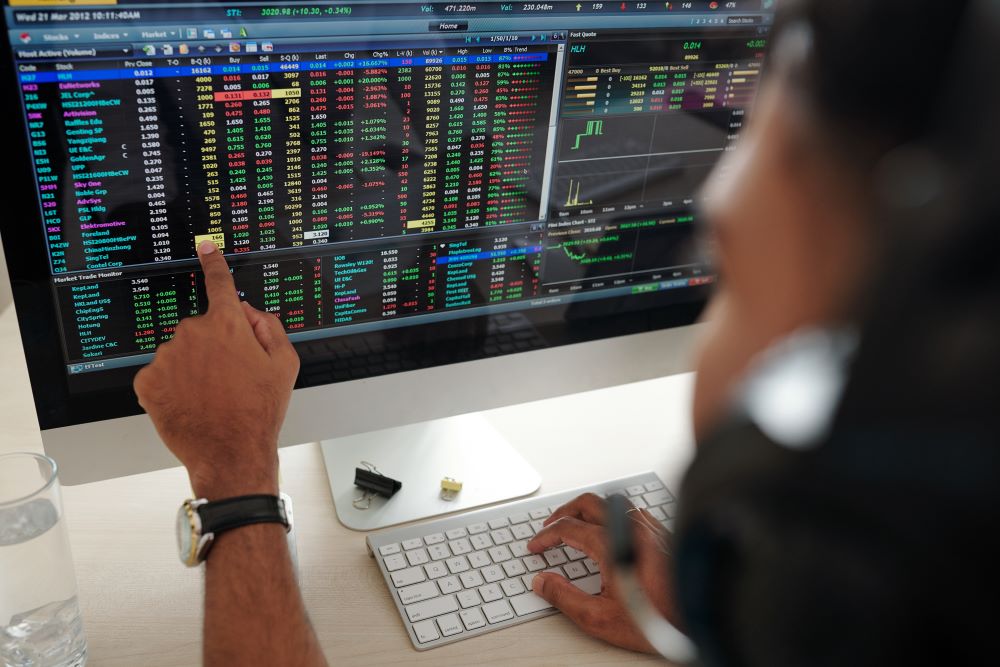 A trader using a laptop to plan purchases and analyze market trends.