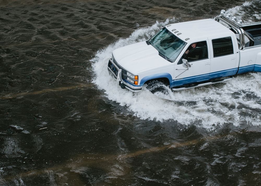 Truck drives through flood waters